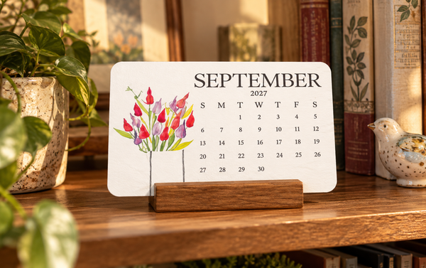 Calendar beside books on a shelf