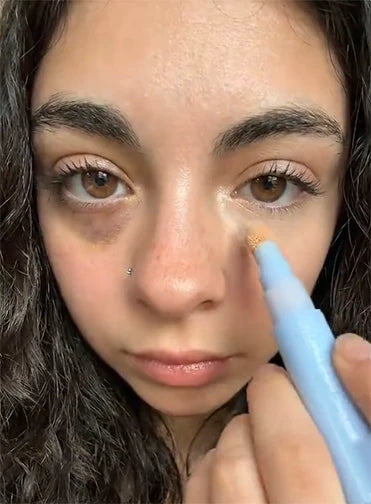 Jessica applying concealer under her eye