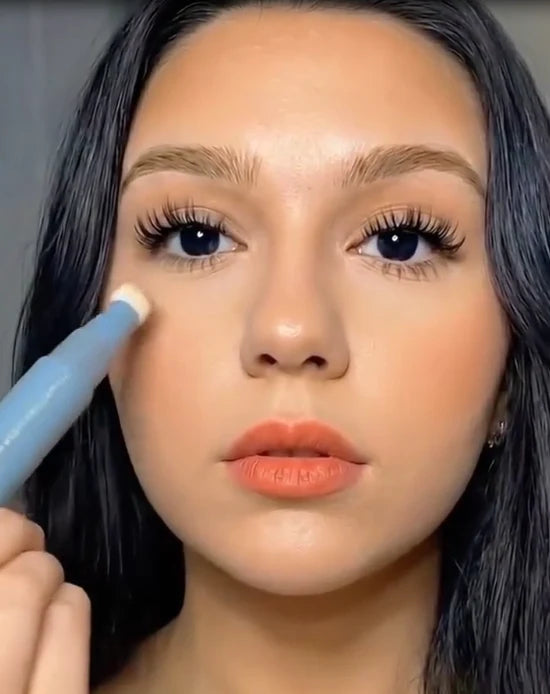 Lauren applying concealer beneath her eye