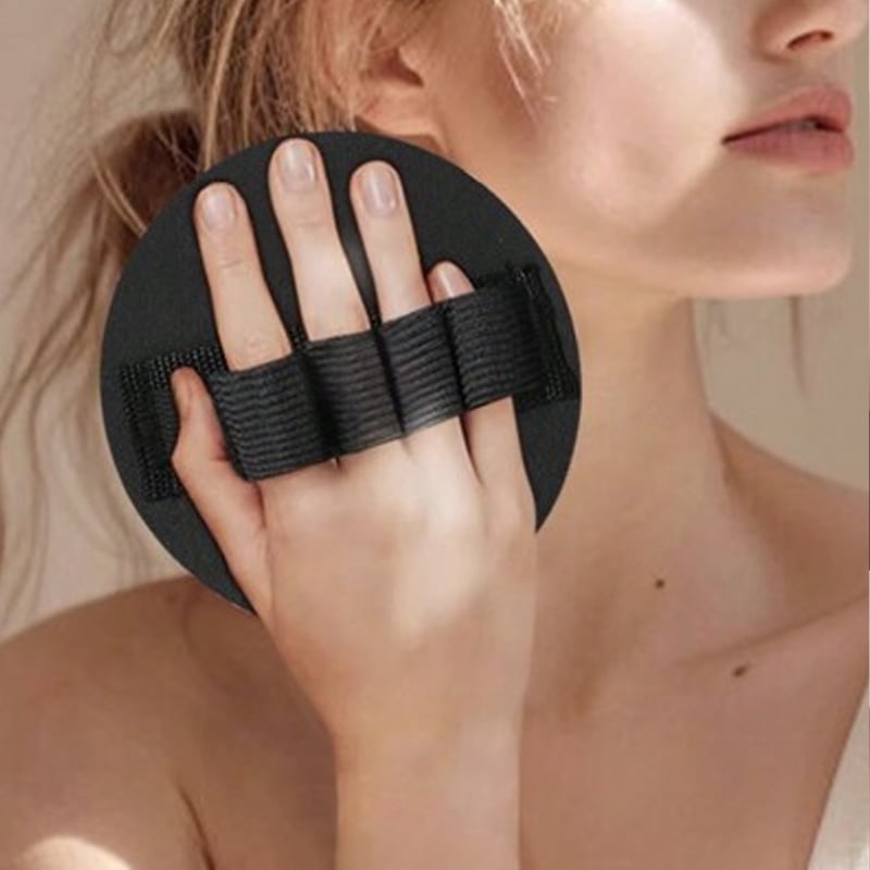 Hand holding the round exfoliating glove